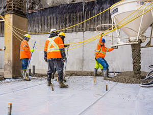 Men pouring concrete on a high rise construction site