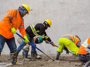 Men pouring concrete on a high rise construction site