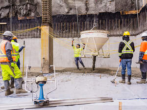 Men pouring concrete on a high rise construction site