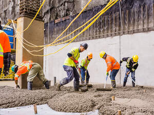 Men pouring concrete on a high rise construction site