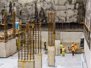 Men pouring concrete on a high rise construction site