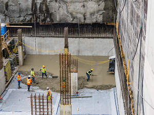 Men pouring concrete on a high rise construction site